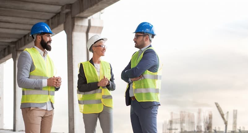 three construction site workers